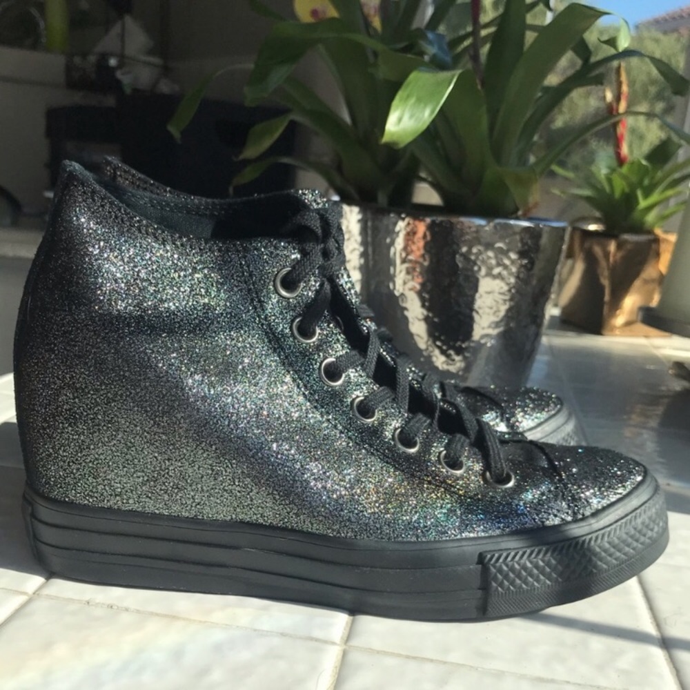 Woman’s hidden wedge converse.